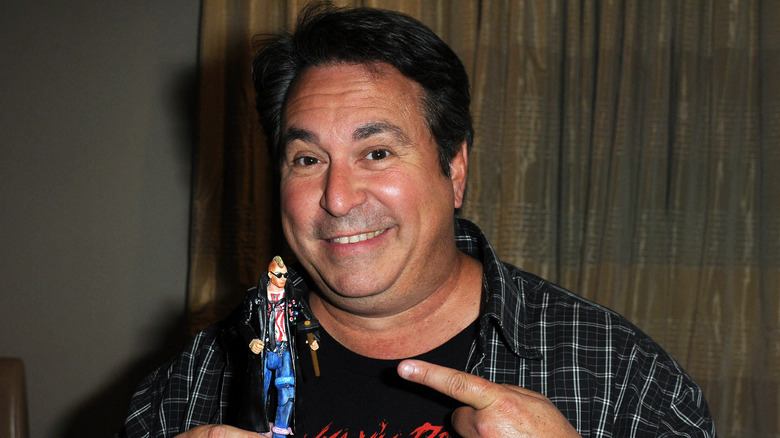 Brian Peck pointing at action figure
