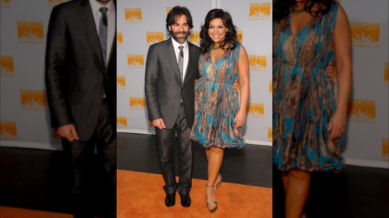 Rachael Ray in a turquoise and bronze dress with husband John Cusimano.