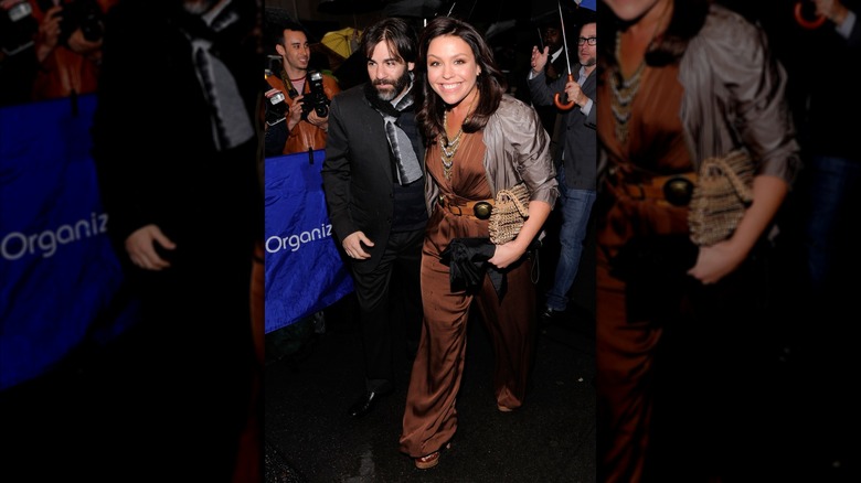Rachael Ray wearing a brown jumpsuit and silver jacket.