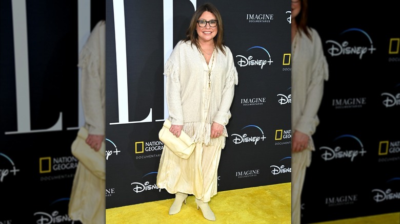 Rachael Ray wearing an off-white baggy shirt, pale yellow maxi skirt, and light beige boots at a National Geographic premiere.