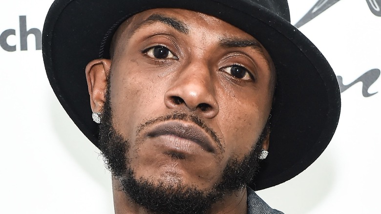 Mystikal wearing hat