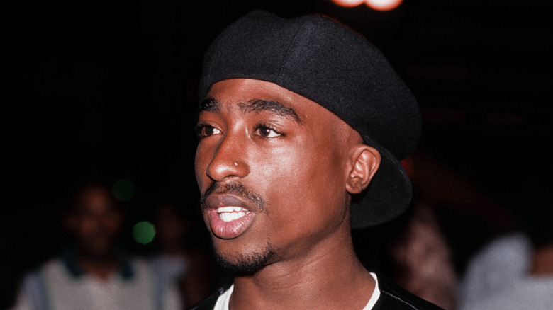 Tupac wearing hat backwards