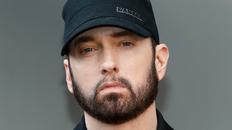 Eminem wearing a black cap