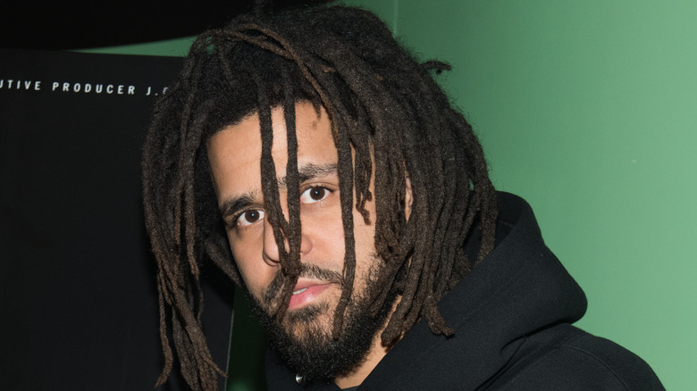 J. Cole wearing a black hoodie