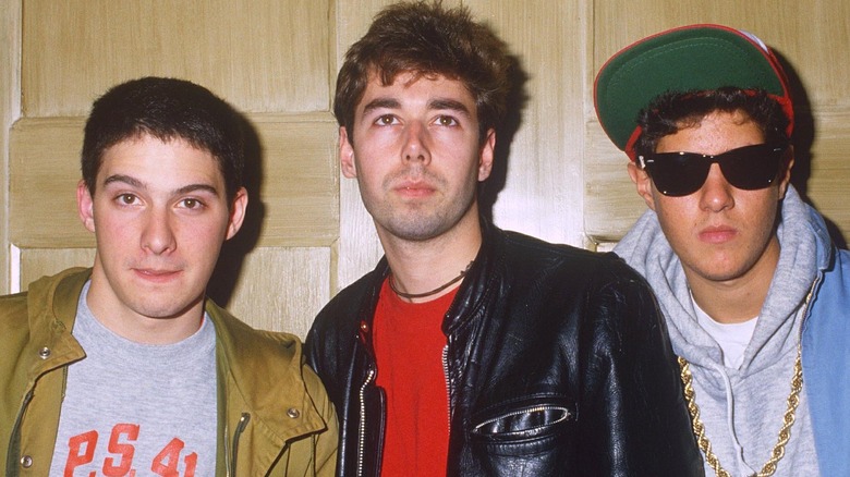Beastie Boys standing in front of a wooden wall