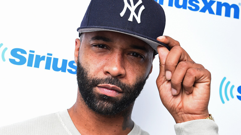 Joe Budden touching his cap