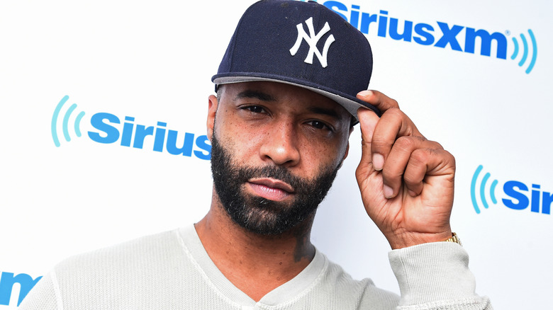 Joe Budden touching his cap