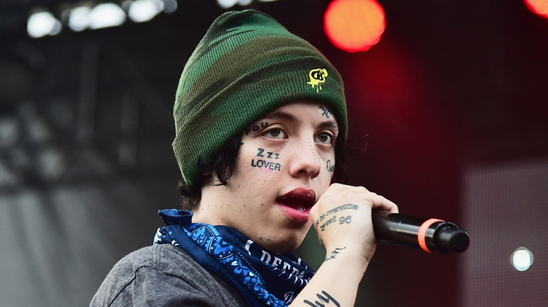 Lil Xan holding a microphone
