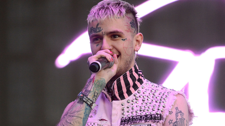 LIl Peep with purple hair holding microphone