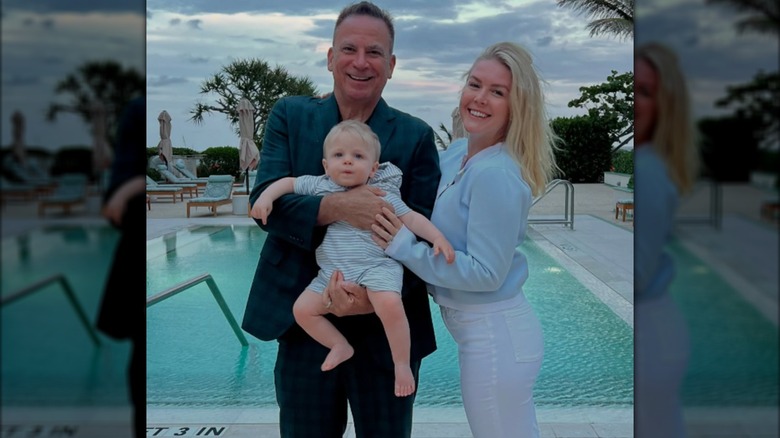 Karoline Leavitt poses at a pool with her husband and their son.
