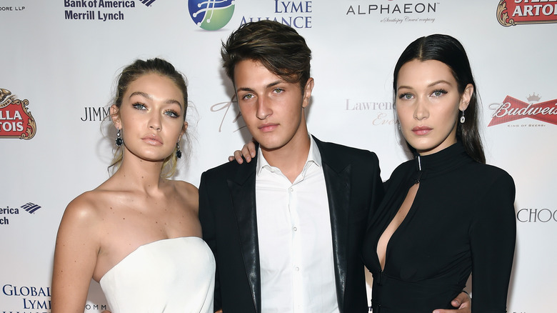 Gigi Hadid, Anwar Hadid, Bella Hadid posing at an event