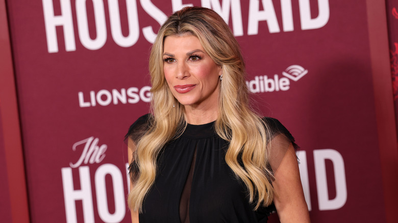 Alexis Bellino posing on step-and-repeat