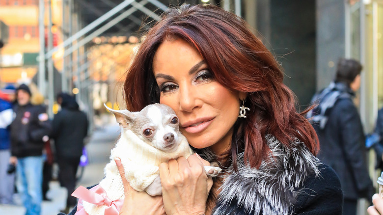 Danielle Staub posing with her dog on streets of New York