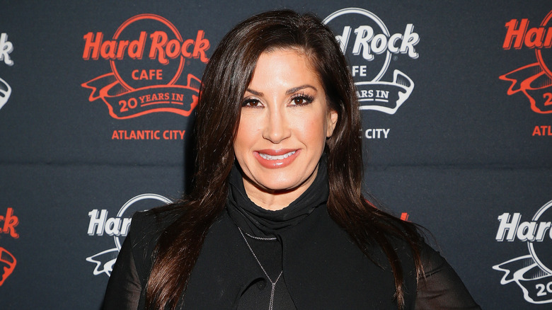 Closeup of Jacqueline Laurita posing on Hard Rock Cafe step-and-repeat