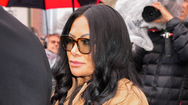 Closeup of Jen Shah leaving federal court surrounded by paparazzi