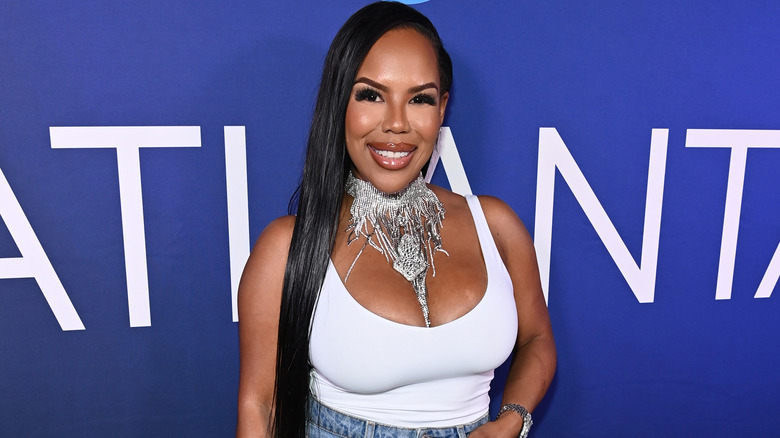 Kelli Ferrell posing in front of a blue background