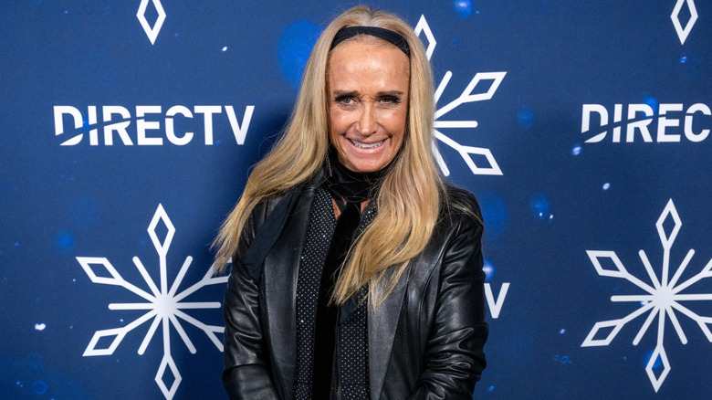 Kim Richards posing on step-and-repeat