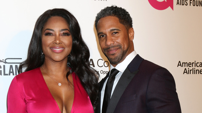 Kenya Moore and Marc Daly posing at an event