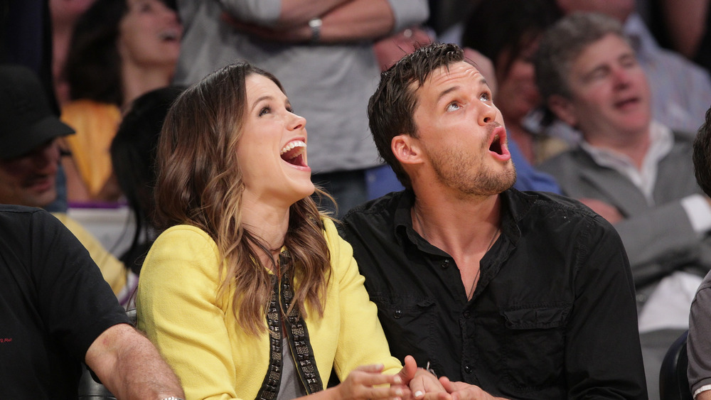 Sophia Bush and Austin Nichols watch basketball