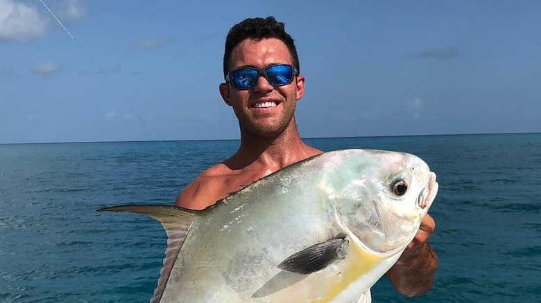 Alex Kompothecras holds a fish in Key West
