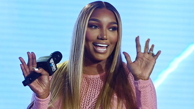 Nene Leakes holding a microphone and smiling