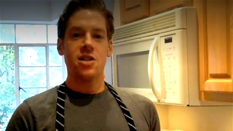 Seth Caro in an apron in the kitchen