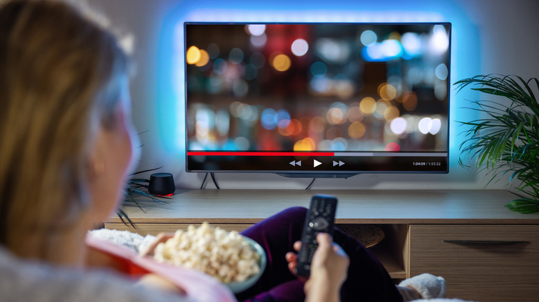 woman watching tv popcorn