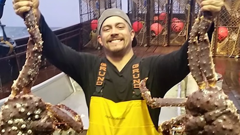 Mahlon Reyes holding crabs on ship