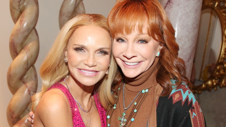 Kristin Chenoweth hugging Reba McEntire