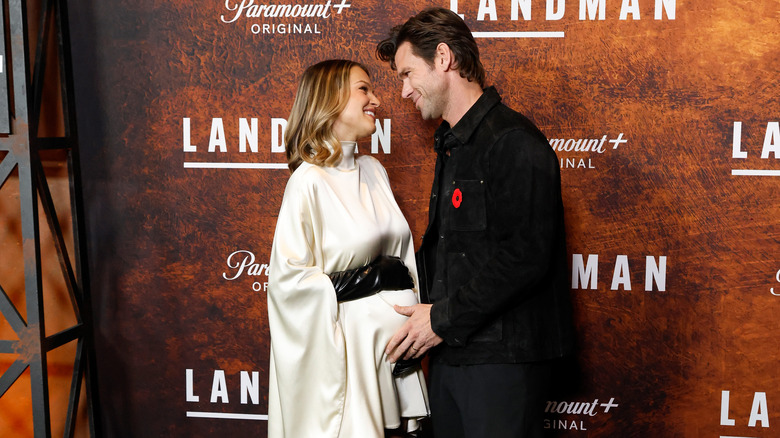Kayla Wallace and Kevin McGarry look at each other as he touches her pregnant belly in 2025