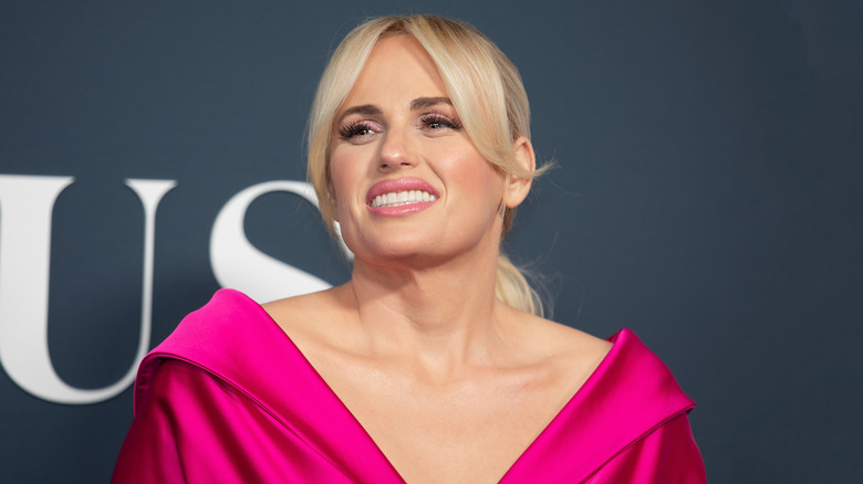 Rebel Wilson posing in a pink dress