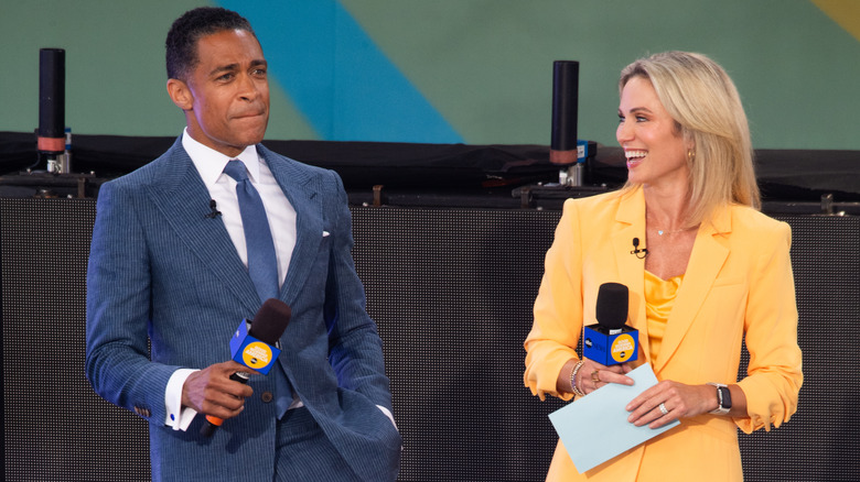 Amy Robach and TJ Holmes laugh while hosting