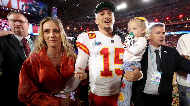 Brittany Mahomes holding Patrick Mahomes arm