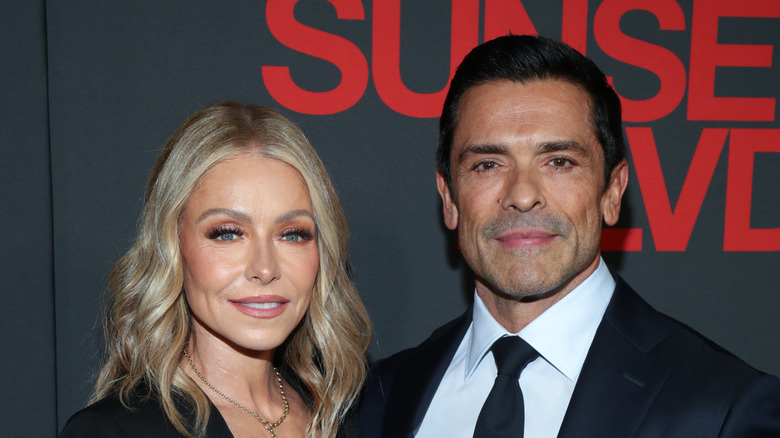 Kelly Ripa and Mark Consuelos looking at camera