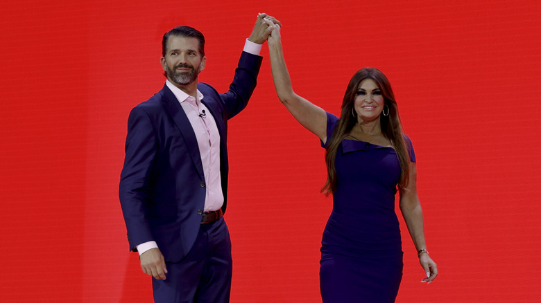 Donald Trump Jr. high fiving Kimberly Guilfoyle before speaking at the annual Conservative Political Action Conference (CPAC