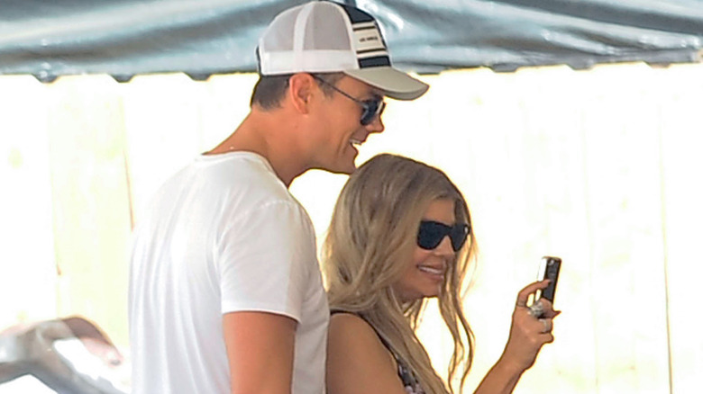 Fergie and Josh Duhamel checking phone