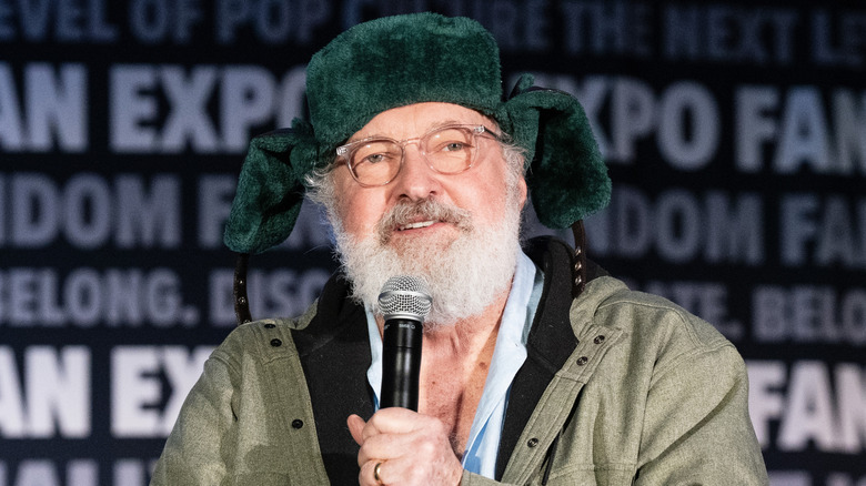 Randy Quaid holds mic at 2024 Fan Expo