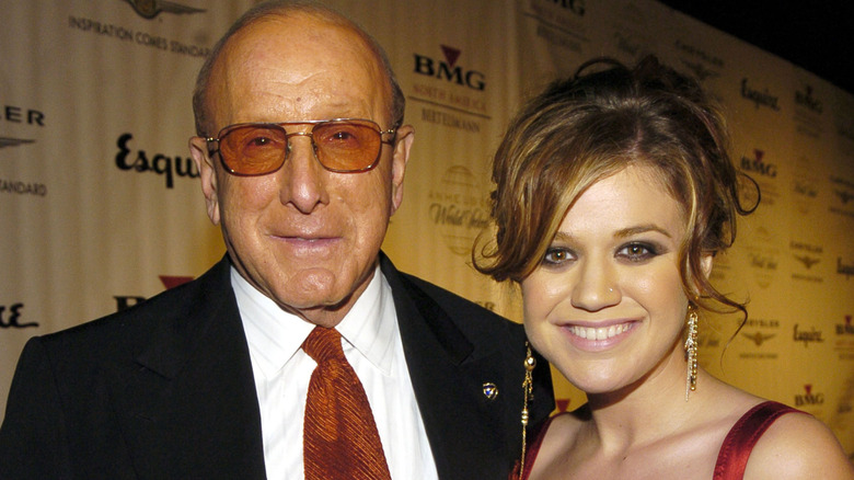 Kelly Clarkson and Clive Davis smiling