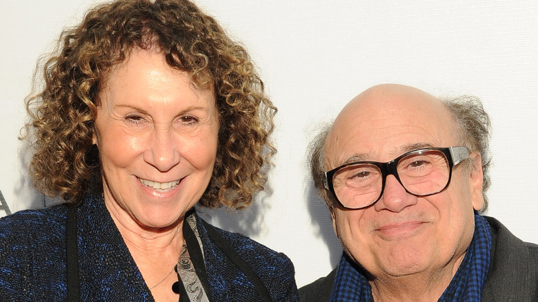 Rhea Perlman and Danny DeVito pose together on a red carpet