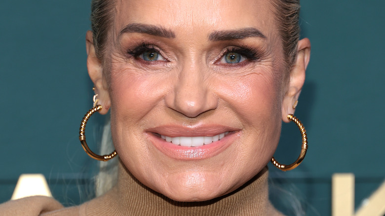 Yolanda Hadid wearing hoop earrings and smiling