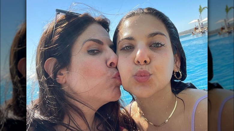 Jennifer Fessler kissing her daughter