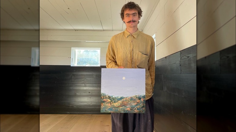 Noel de Lesseps holding a painting