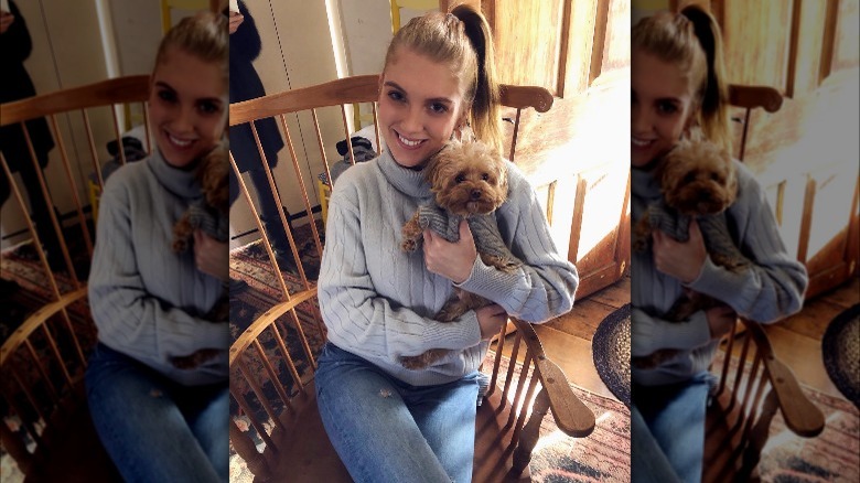 Avery Singer holding dog Coco