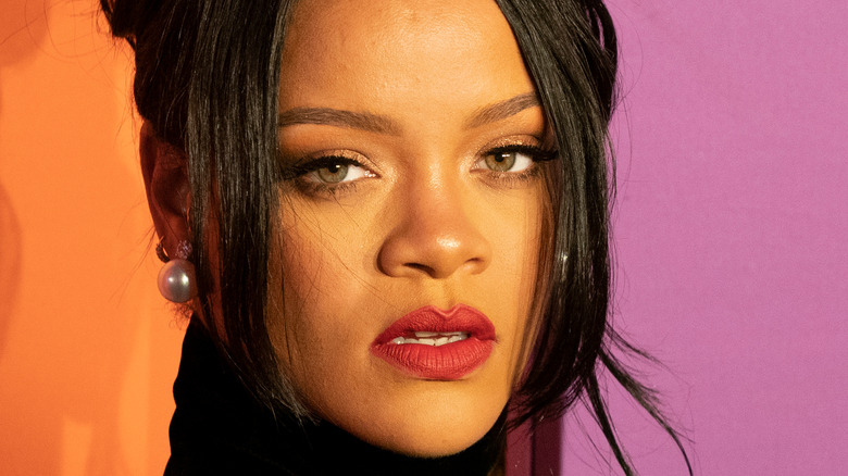 Rihanna posing in red lipstick