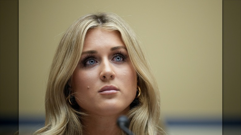 Riley Gaines with a lot of eye makeup.