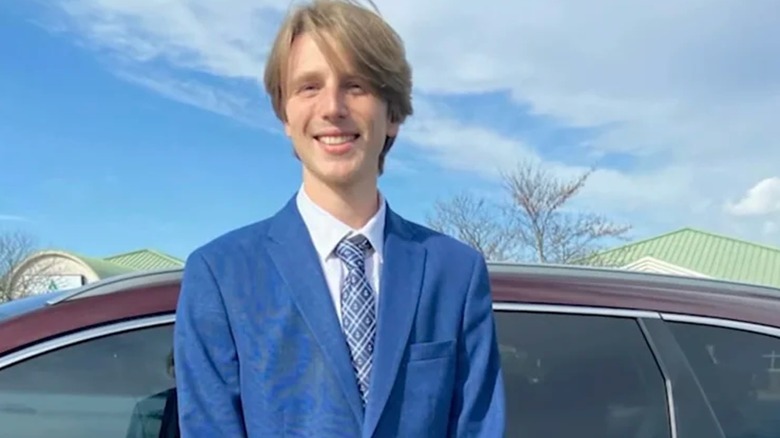 Riley Strain smiling next to car