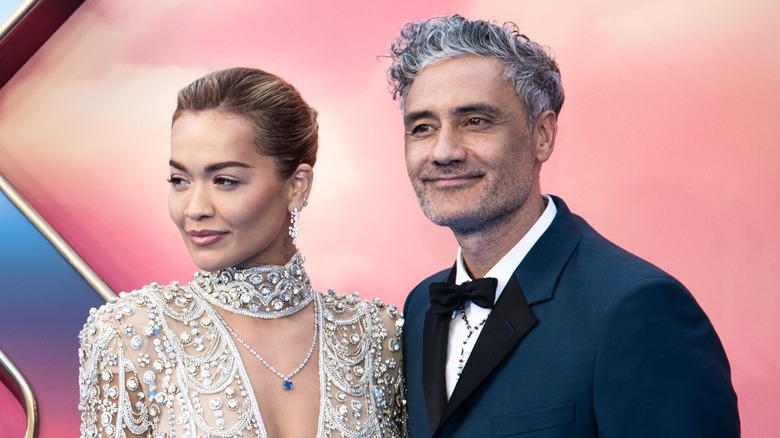 Rita Ora in bejeweled dress poses with Taika Waititi 