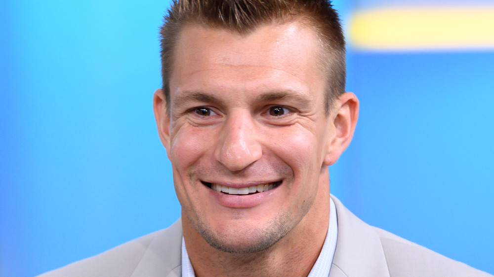 Rob Gronkowski smiles in light suit