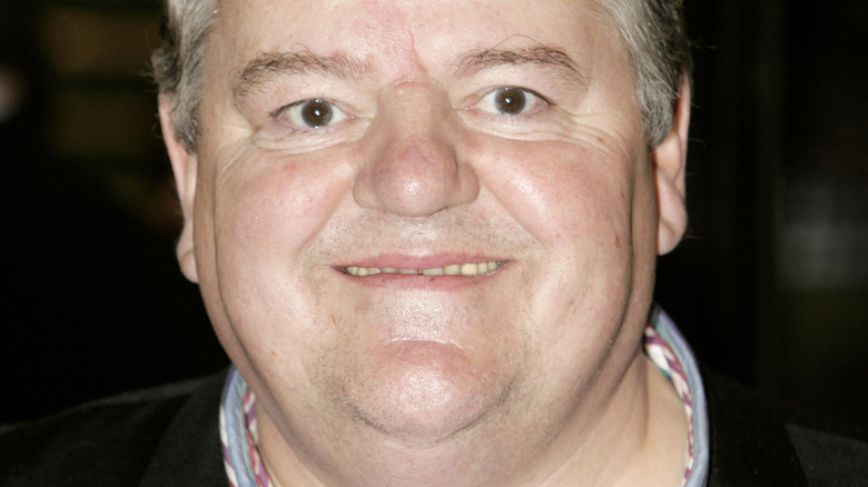 Robbie Coltrane smiling on the red carpet 