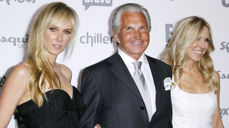 Kimberly and Alana Stewart posing with George Hamilton 